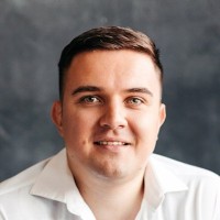 Lou_Reverchuk seen posing for a photo from a grey color background